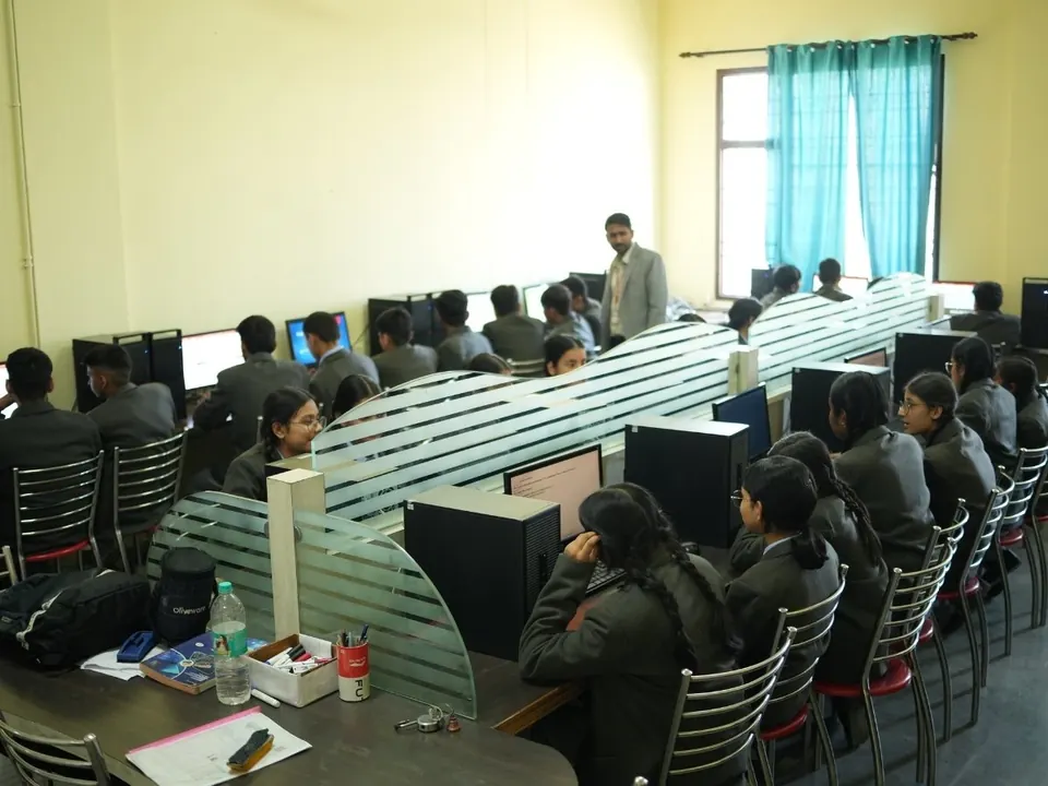 Students work at computers in a computer lab