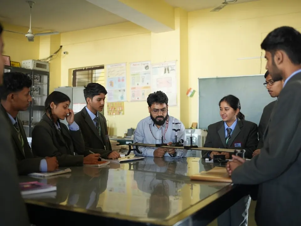 Students and a teacher work together at a laboratory table